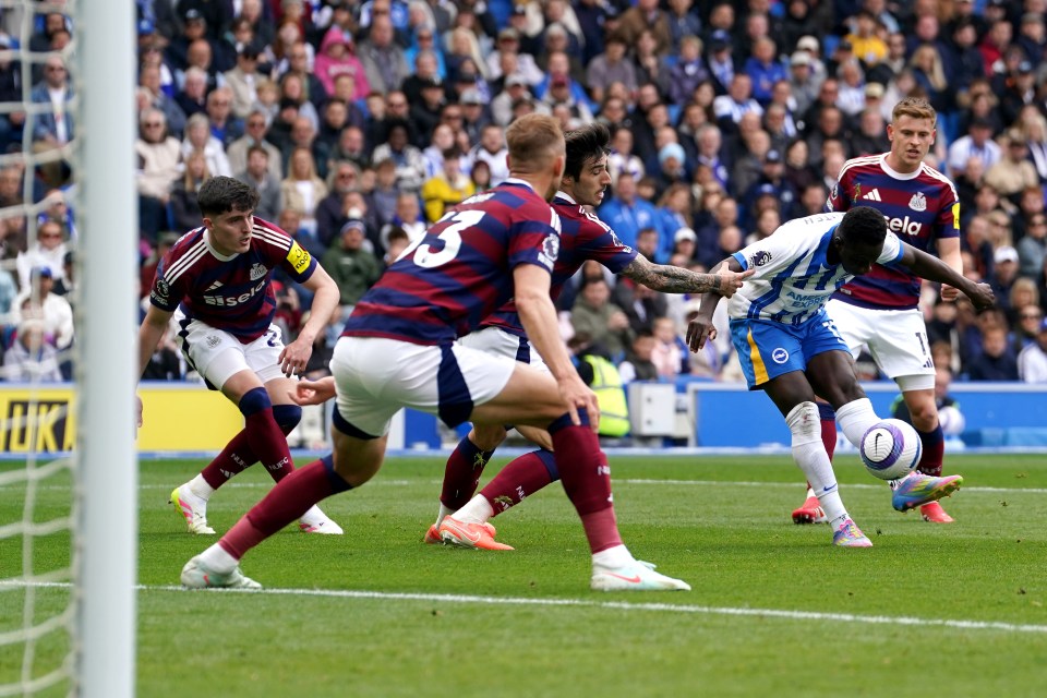 Soccer player scoring a goal.