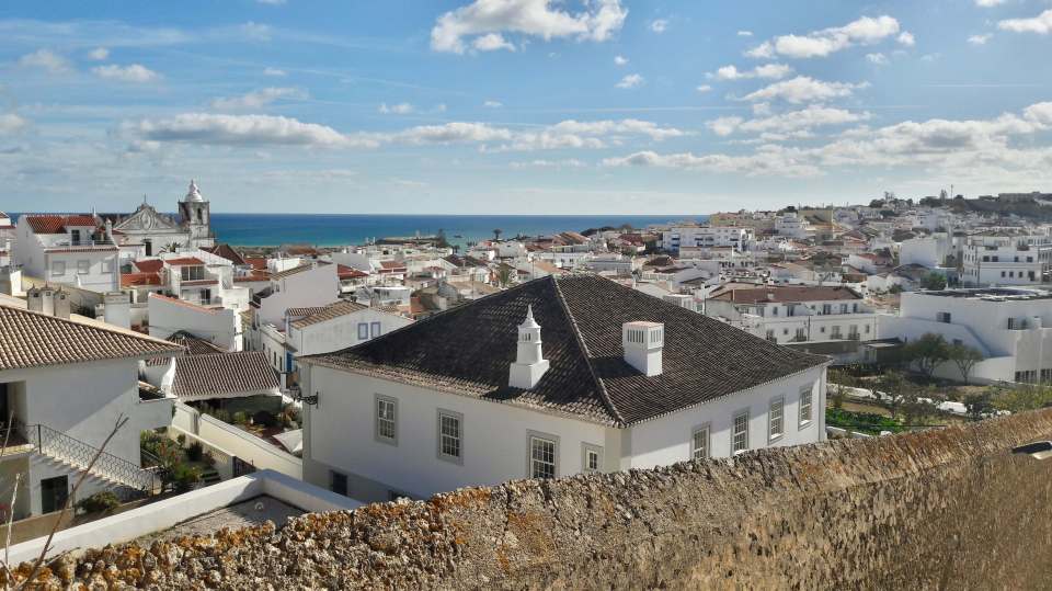 Overlooking Lagos, Portugal, showing whitewashed buildings, red tile roofs, and the ocean.