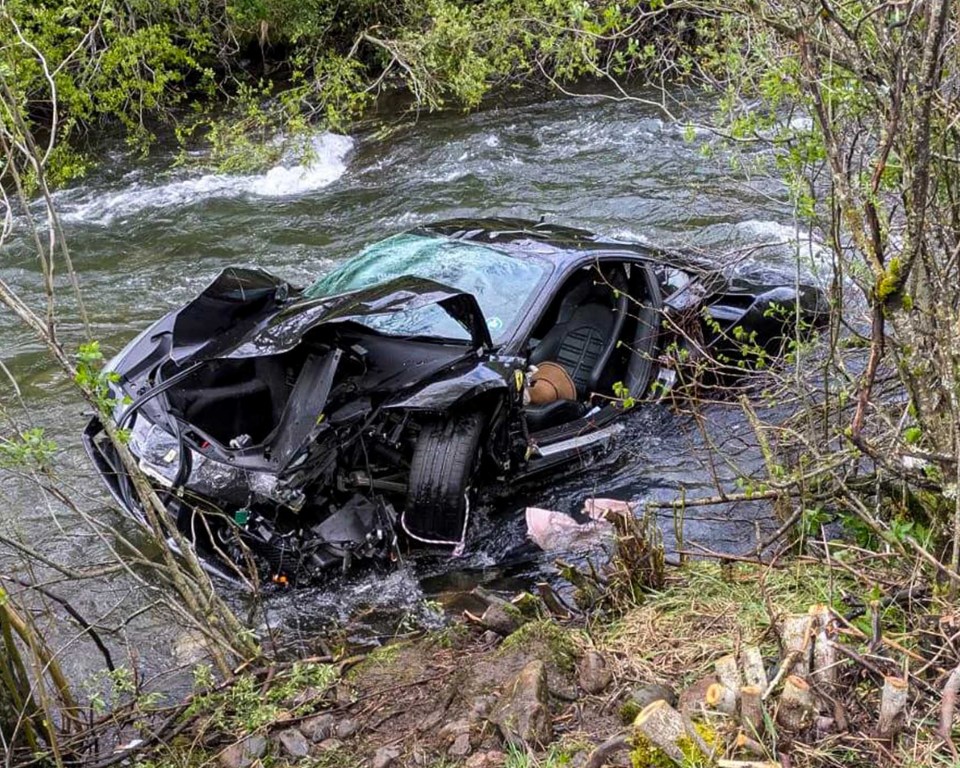 Severely damaged Ferrari in a river.