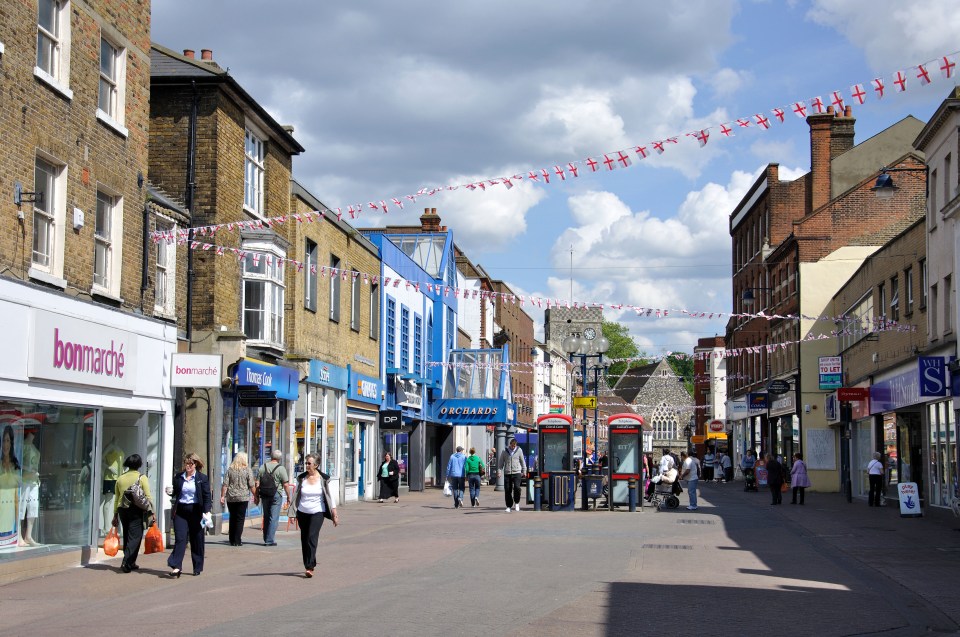 High street in Dartford, Kent with shops and pedestrians.