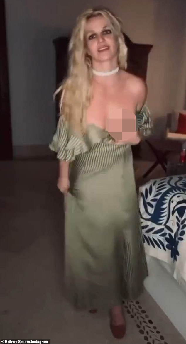 At one point, Britney brought her hands down towards her sides and upon doing so, accidently brushed the top portion of the dress - which brought the fabric down below her left breast