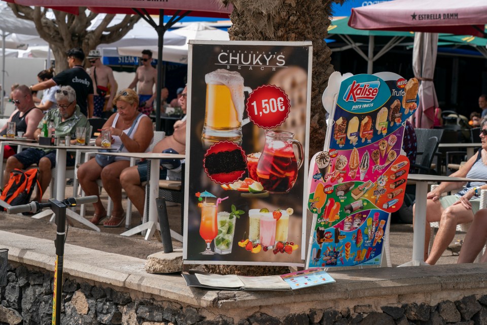 Tenerife restaurant menu boards showing beer, sangria, cocktails, ice cream, and other treats.