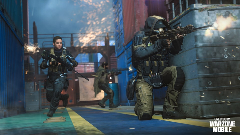 Soldiers in tactical gear engaging in combat in a warzone.