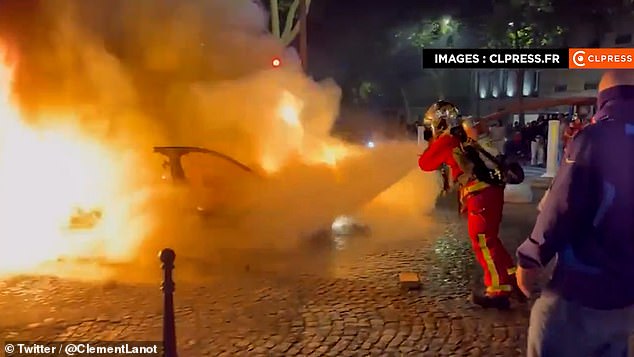 A car was today set alight by a gang of youths after driving into football fans celebrating Paris Saint-Germain's victory over Arsenal in the French capital
