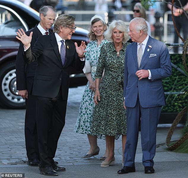 Britain's King Charles, patron of the Royal Horticultural Society, and Queen Camilla are met by Keith Weed, president of the RHS