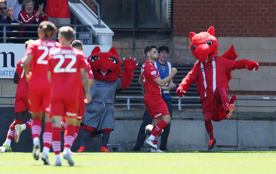Leyton Orient's Charlie Kelman celebrates a goal with mascots.