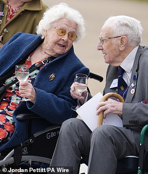 A veteran of the Women's Royal Naval Service, Betty Hollingberry was one of six sent to work on HMS Pembroke V in Eastcote, west London, where she helped operate the Bombe machines designed to break German Enigma codes. Above: Mr Hollingberry with fellow veteran John Mortimer in the gardens of Buckingham Palace, London, to view the fly past today