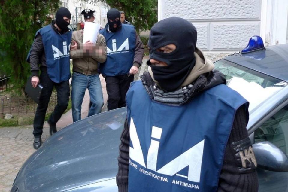 Anti-mafia police officers arresting a suspect.