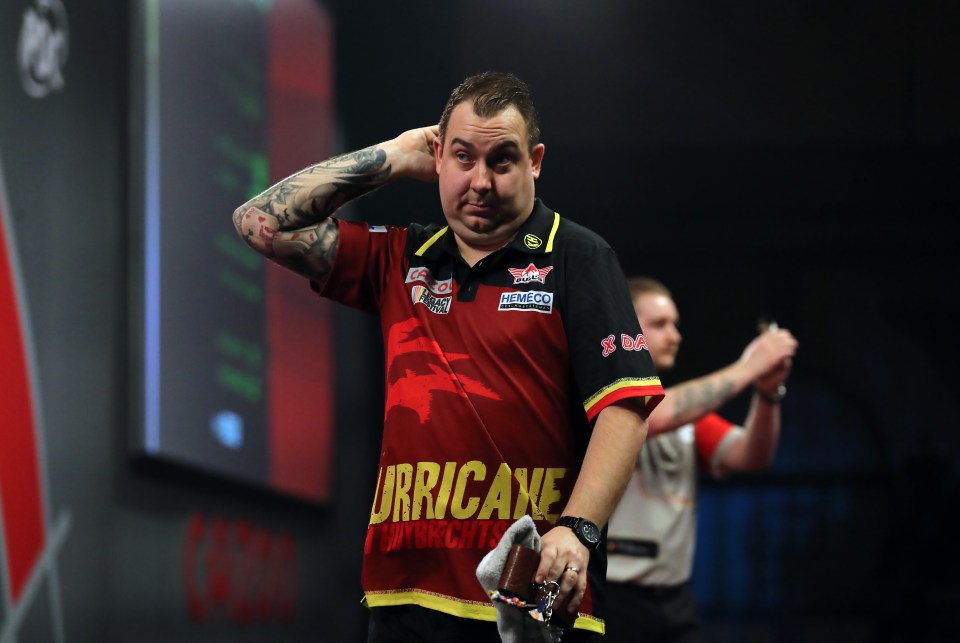 Kim Huybrechts walks off stage after losing a darts match.