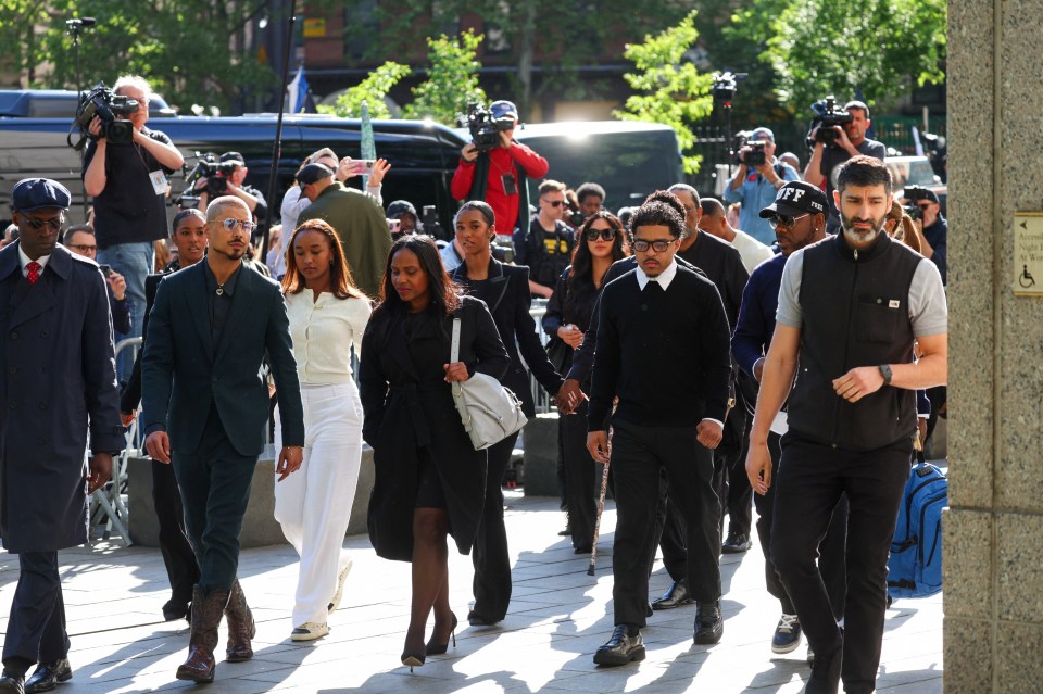 Justin Combs and Quincy Brown walking outside a courthouse.