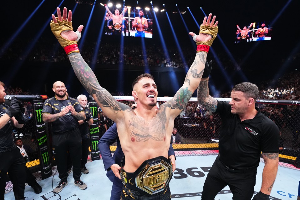 Tom Aspinall celebrates his UFC heavyweight championship victory.