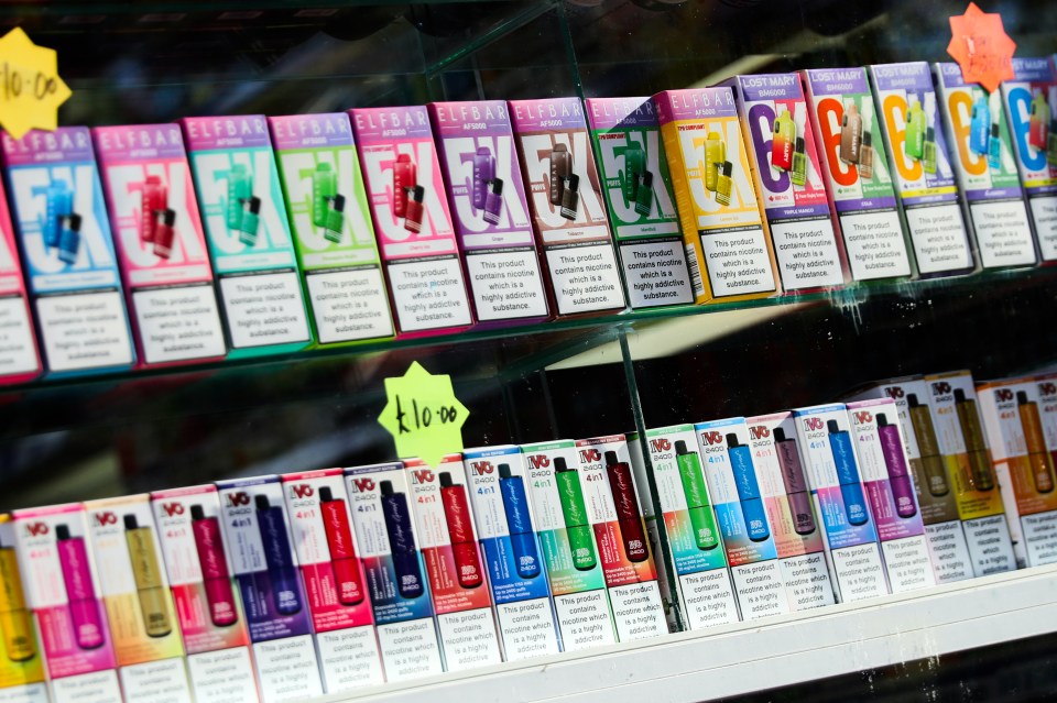 Display of various disposable vapes for sale.