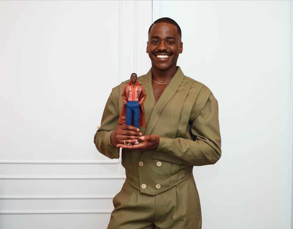 Ncuti Gatwa holding his Doctor Who Barbie doll.