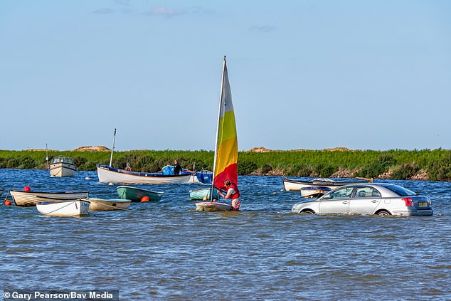 Drivers have been hit by a Bank Holiday headache after their cars got carried into the sea at Burnham Overy Staithe in Norfolk, also interfering with an RNLI boat race