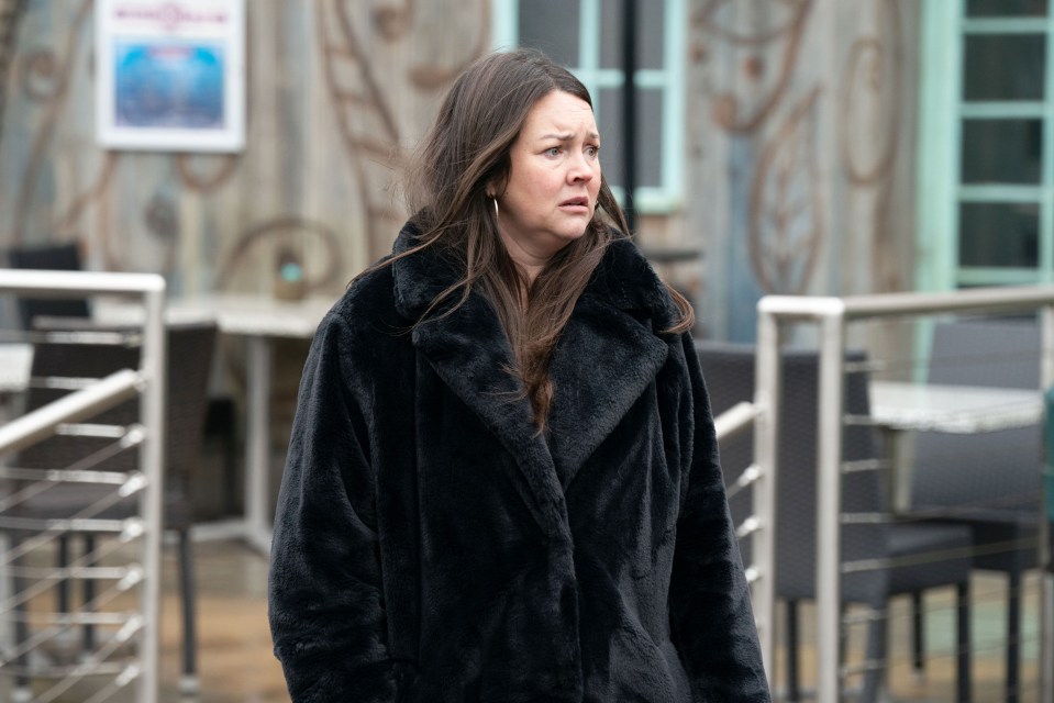 Stacey Slater from EastEnders in a black coat.
