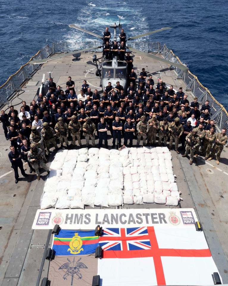 Royal Navy crew posing with seized narcotics on HMS Lancaster.