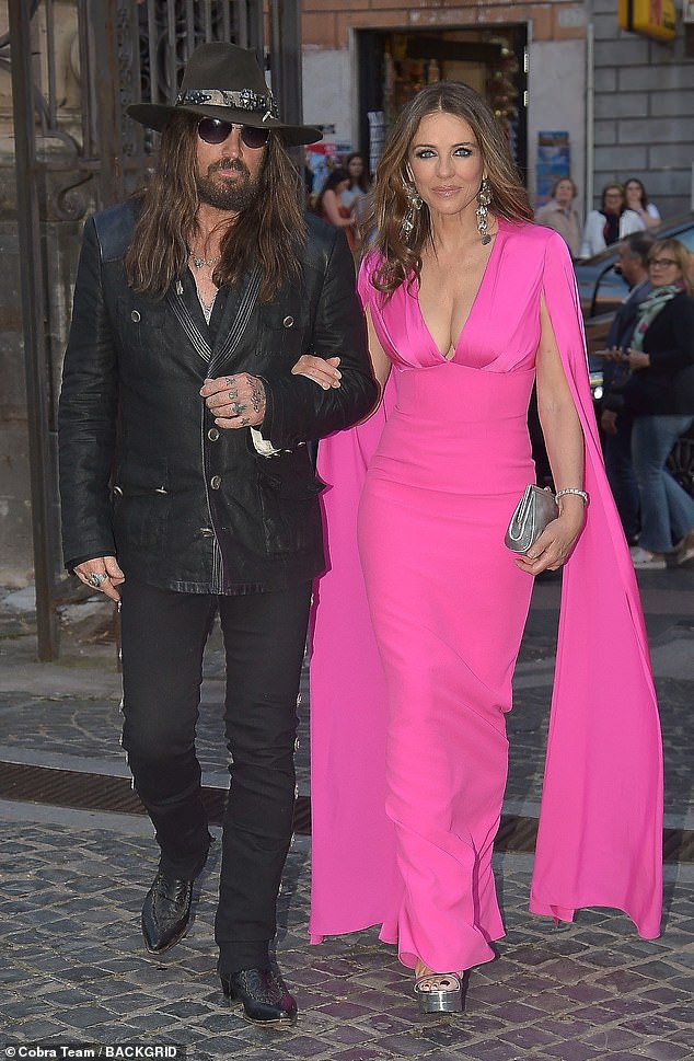 Elizabeth Hurley, 59, and Billy Ray Cyrus, 63, put on a loved up display as they made their first public outing as a couple at a Valentino bash in Rome on Saturday evening