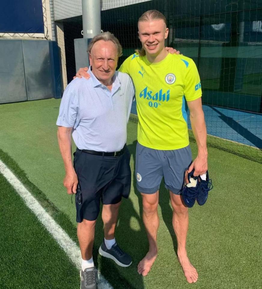 Erling Haaland and Neil Warnock on a soccer field.