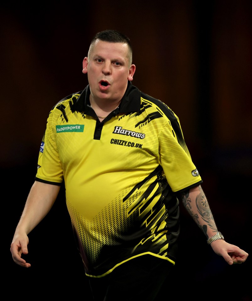 Dave Chisnall of England celebrating during a darts match.