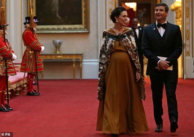 New Zealand Prime Minister Jacinda Ardern walks through Buckingham Palace with her husband Clarke Gayford on April 19, 2018. She was seven months pregnant at the time