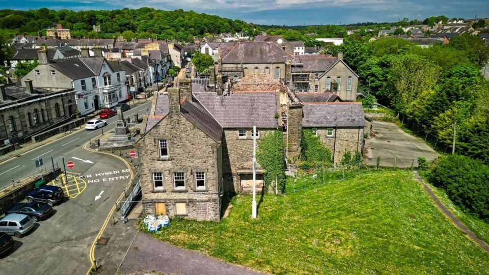 Aerial view of a dilapidated Jacobean mansion for sale in Wales.