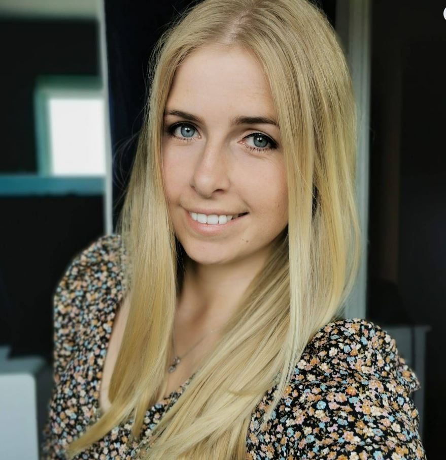 Portrait of a young woman with long blonde hair.