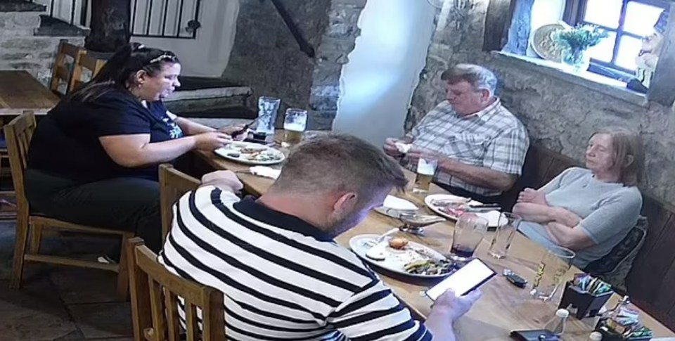 A family sitting at a table in a restaurant.