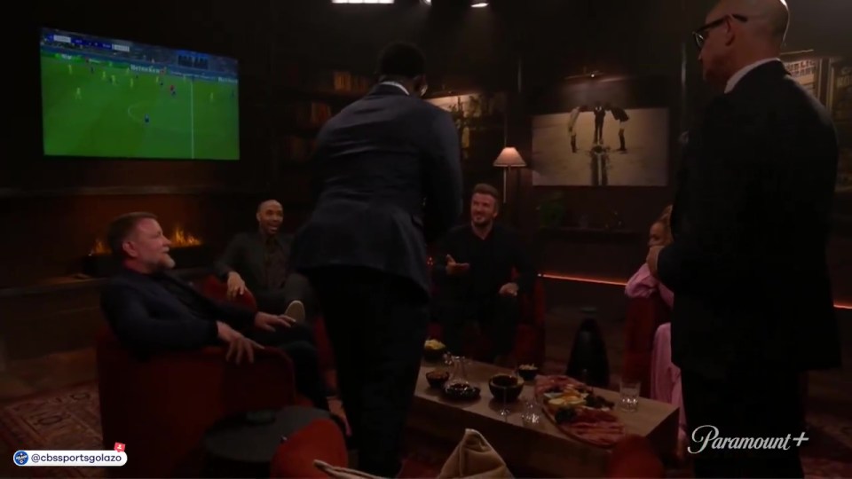 Micah Richards sitting on David Beckham's lap during a show.