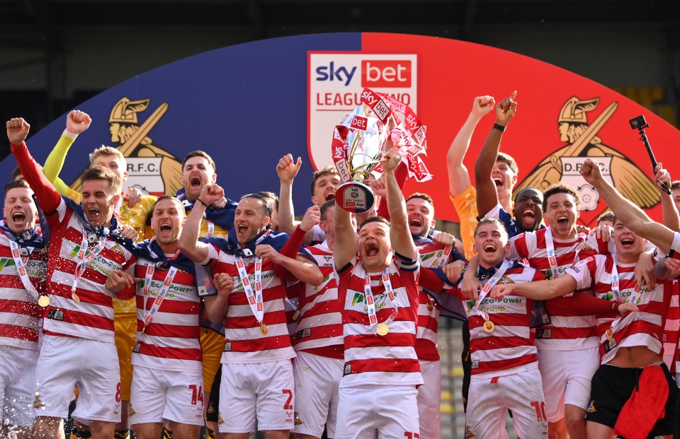 Doncaster Rovers team celebrating their Sky Bet League Two Championship win.