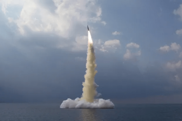 a rocket is launched into the sky over the ocean