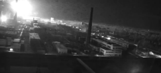 Nighttime view of an explosion at an industrial site.