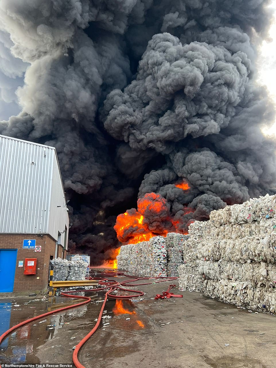 Fire crews were called to the inferno at Monoworld recycling centre on the Sanders Lodge Industrial Estate, Rushden, at around 6.30am today