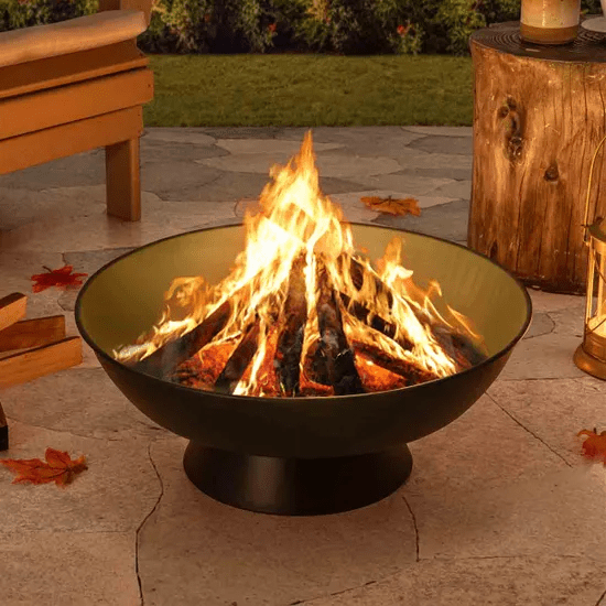 Steel fire pit with burning wood.