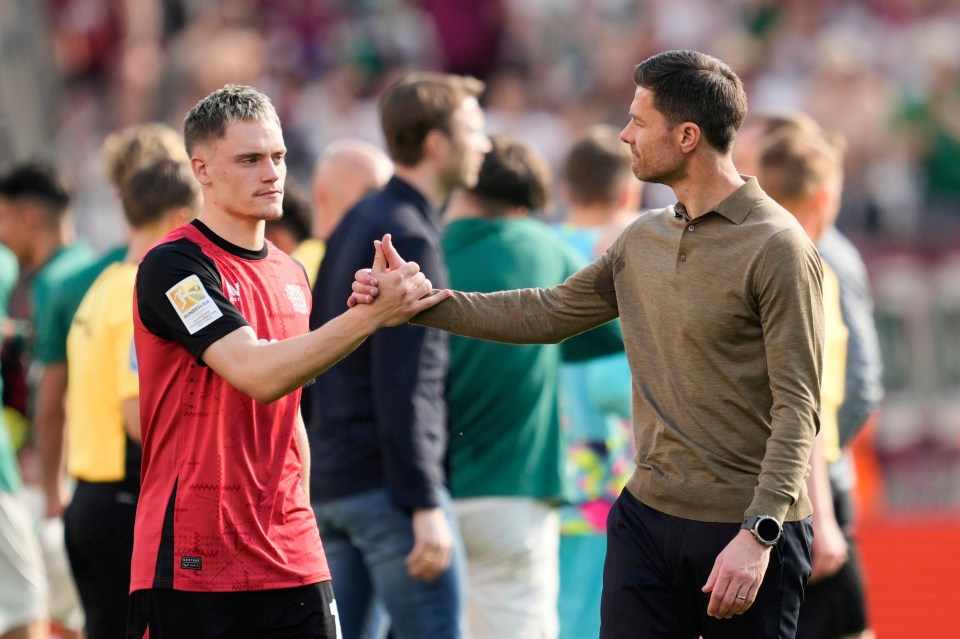 Xabier Alonso shaking hands with Florian Wirtz.