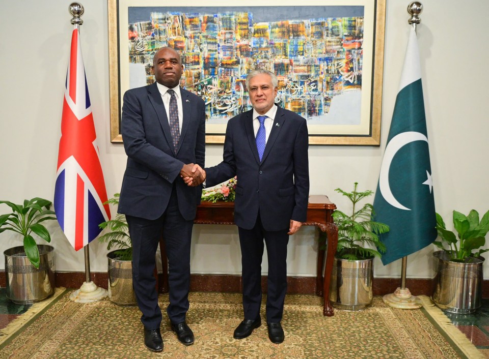 Pakistan's Foreign Minister Ishaq Dar and Britain's Foreign Secretary David Lammy shaking hands.