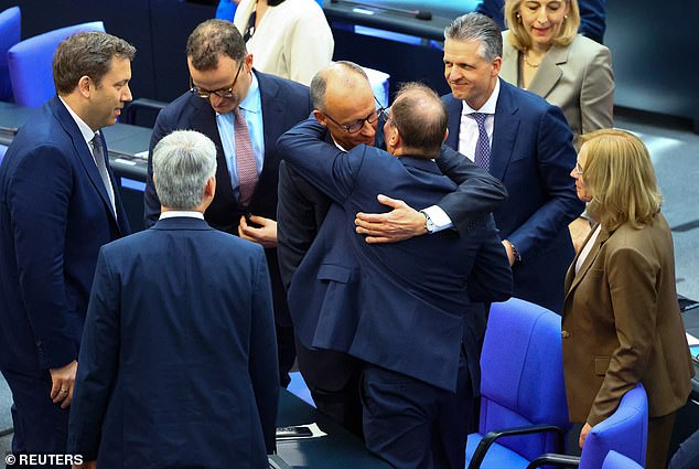 Germany's Incoming Chancellor Friedrich Merz is congratulated as he is elected chancellor by parliament in second round of voting in the German lower house of parliament Bundestag