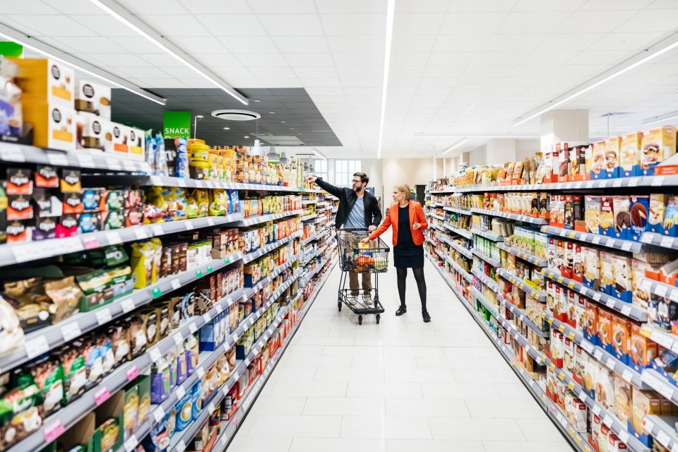 A mature couple grocery shopping in a supermarket.