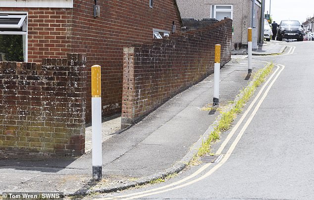 A set of bollards in Swindon have been painted to look like cigarettes being stubbed out