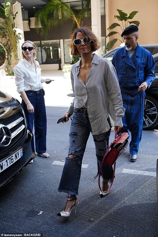 The Catwoman star, 56, opted for an oversized striped button-up shirt with a pair of distressed cropped boyfriend jeans for the outing