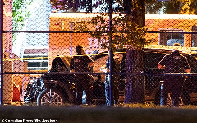 Vancouver Police look over a black car involved in the incident at the Lapu Lapu Festival
