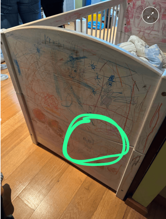 Children's drawings on a crib.