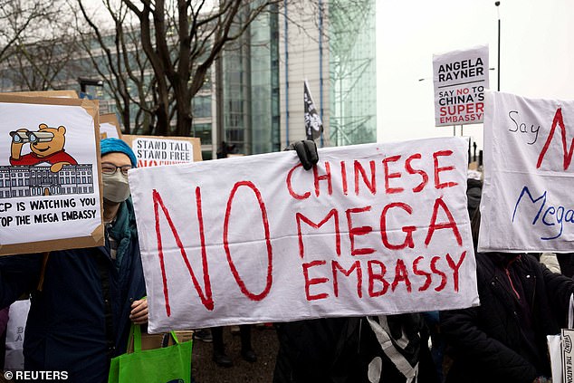 In a speech, the activist argued that allowing Beijing to build such a large embassy sends out the 'wrong message' that Britain welcomes authoritarian regimes. Pictured: A demonstrator holds up a flag with the message 'No Chinese mega embassy' in February