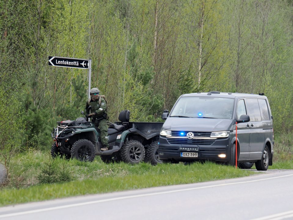 Police ATV and van at helicopter crash site.