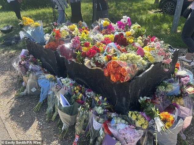 Floral tributes are seen outside Bicester Fire Station following a fire at Bicester Motion