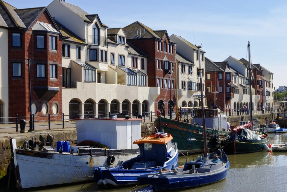 Boats moored at a harbor in Maryport, Cumbria, England.