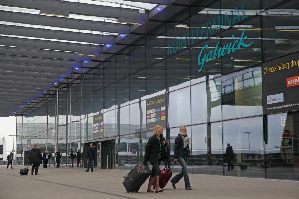 Passengers with luggage at Gatwick Airport's North Terminal.