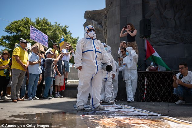 Several activists stage a performance, pouring waste and sewage water on Canary Islands politicians