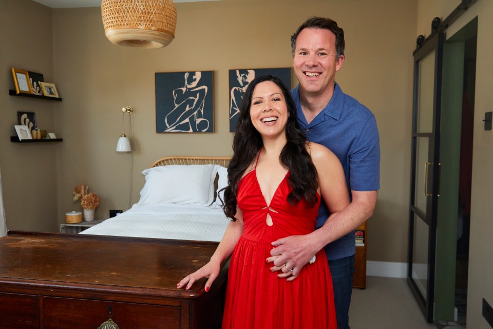 A couple embracing in their bedroom.