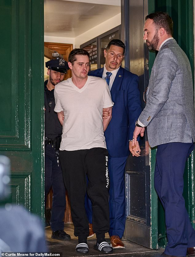 John Woeltz, 37, pictured with police after his shocking arrest on charges of assault, kidnapping, unlawful imprisonment, and criminal possession of a firearm