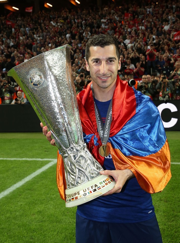 Henrikh Mkhitaryan of Manchester United holding the Europa League trophy.